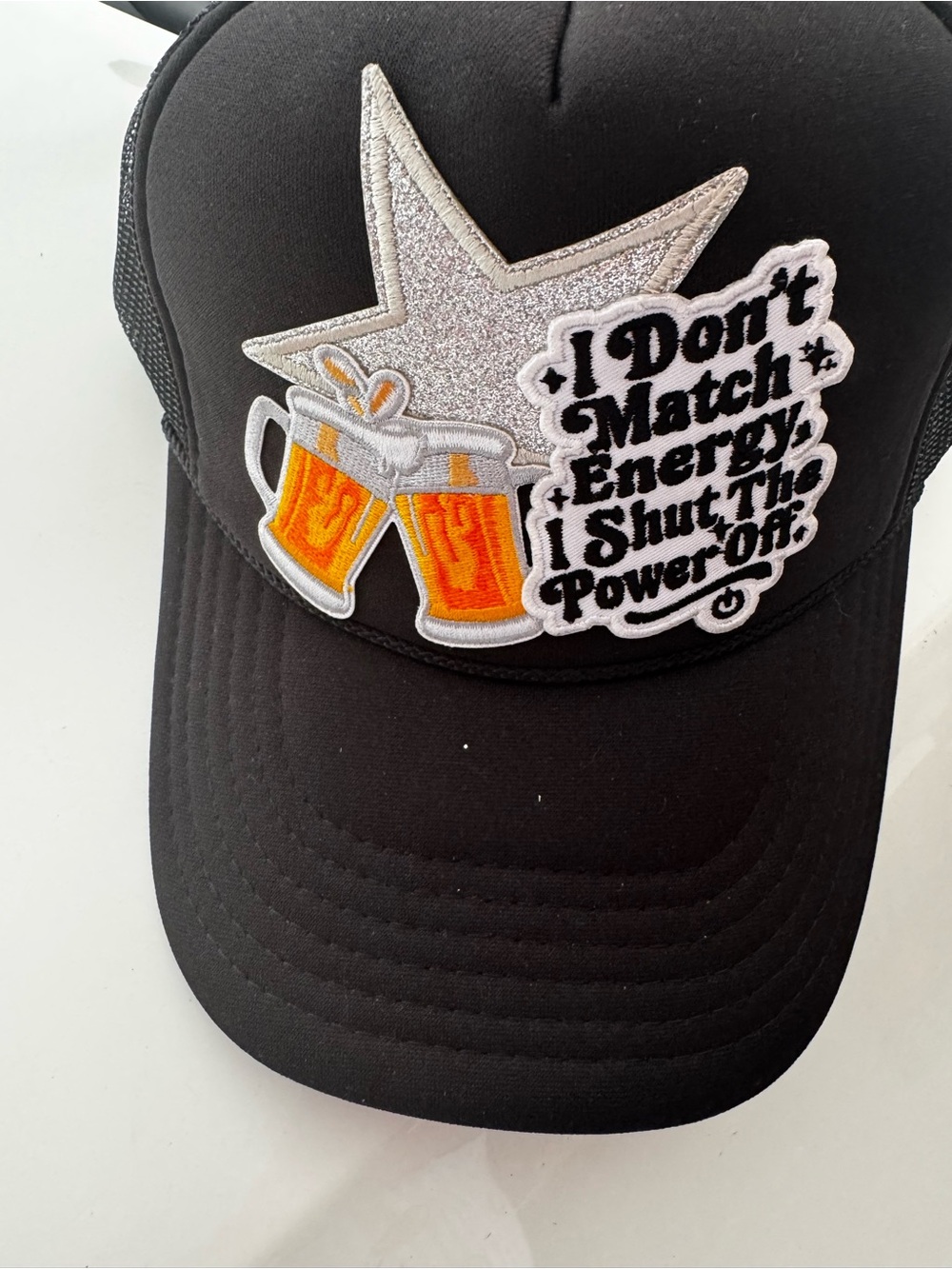 Black Trucker Cap with 'Don't Match Energy' Patch